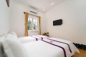 Postel nebo postele na pokoji v ubytování The Sim Hotel Vung Tau