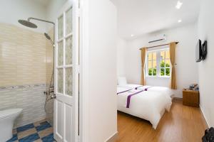 Postel nebo postele na pokoji v ubytování The Sim Hotel Vung Tau