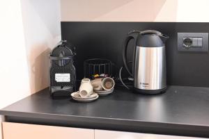 a kitchen counter with a tea kettle and shoes at CastelFidardo Dimore - MONOPOLI in Monopoli