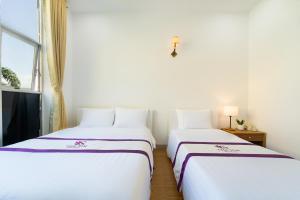 Postel nebo postele na pokoji v ubytování The Sim Hotel Vung Tau