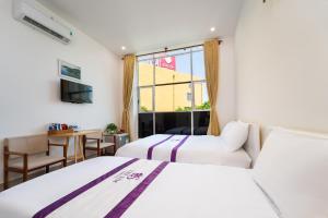 Postel nebo postele na pokoji v ubytování The Sim Hotel Vung Tau