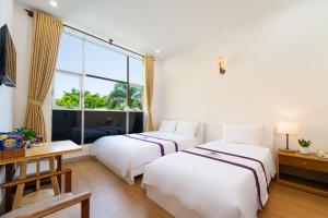 Postel nebo postele na pokoji v ubytování The Sim Hotel Vung Tau