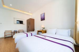 Postel nebo postele na pokoji v ubytování The Sim Hotel Vung Tau