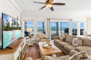 a living room with a large tv and a couch at TSC404 - Seaclusion in Kill Devil Hills