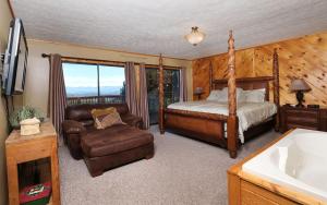 a bedroom with a bed and a chair and a tub at An Unforgettable Cabin in Sevierville