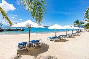 a row of chairs and umbrellas on a beach at Paradise Resort Nha Trang in Nha Trang