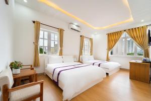 Postel nebo postele na pokoji v ubytování The Sim Hotel Vung Tau