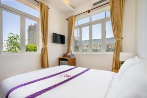 Postel nebo postele na pokoji v ubytování The Sim Hotel Vung Tau