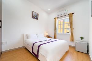 Postel nebo postele na pokoji v ubytování The Sim Hotel Vung Tau