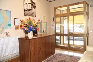 a lobby with a counter with a vase of flowers at Hotel San Vincenzo in Soverato Marina