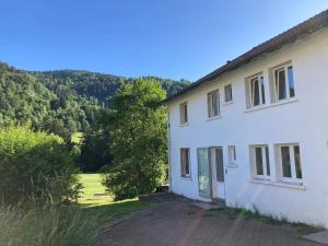 a white house with a view of a field at Le Gîte d'Orion in La Bresse