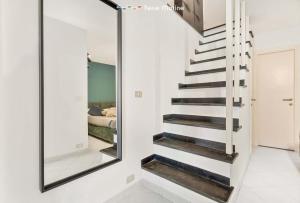 a staircase in a room with a mirror at Mangia, Prega, Ama TerreMarine in Riomaggiore
