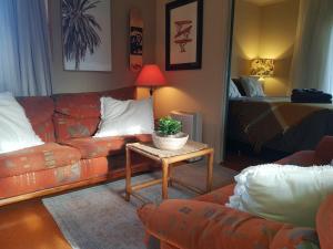 a living room with a couch and a table at Country Cutie-Pie, close to town in Hastings