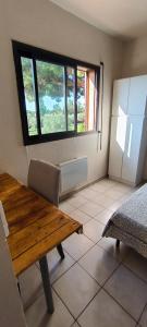 a dining room with a table and a refrigerator at appartement proche zenith in Montpellier