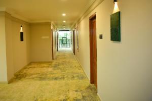 an empty hallway in a building with a painting on the wall at Hotel Manal Suites in Green Island +15 photos