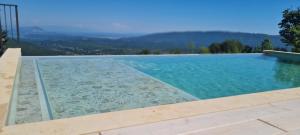 a swimming pool with a view of the mountains at Tinyhouse Dapčevići - Montenegro in Bar