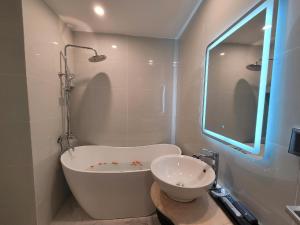a bathroom with a bath tub and a sink at Hanoi Old Town in Hanoi +25 photos