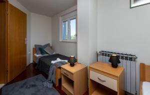 a small bedroom with a bed and two night stands at Country house Maslina by Villas Guide in Metković +34 photos
