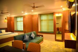 a living room with a couch and a bed at Hotel Manal Suites in Green Island