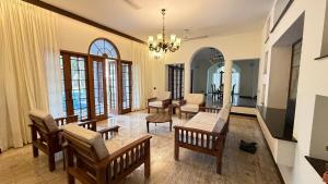 a living room with a table and chairs at Wilson Guest House in Chennai