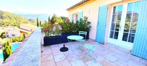 a patio with a table and chairs on a balcony at Le mas christiane in Buis-les-Baronnies