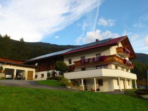 a large building with a balcony on top of it at Ferienwohnung Berghof Pixner in Wenns
