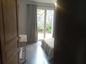 a room with a bed and a door with a window at Ô 17 i aime in Le Tampon +16 photos