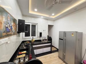 a kitchen with a refrigerator and a counter top at Sagar Villa Udaipur in Udaipur