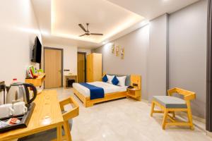 a hotel room with a bed and a desk at Hotel Zest Near IGI Airport in New Delhi