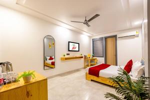 a bedroom with a bed and a mirror at Hotel Zest Near IGI Airport in New Delhi