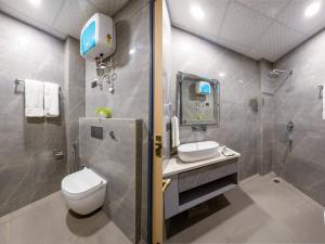 a bathroom with a toilet and a sink and a shower at Hotel Zest Near IGI Airport in New Delhi +34 photos