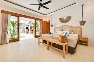 a bedroom with a bed and a table at Villa Mawali in Legian +89 photos