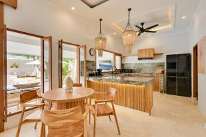 a kitchen with a table and chairs and a counter at Villa Mawali in Legian