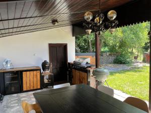 a kitchen with a black table and a stove at COM Home Sovata in Sovata