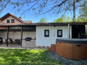 a house with a hot tub in the yard at COM Home Sovata in Sovata
