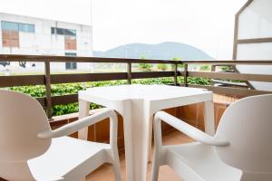 a white table and chairs on a balcony at Apartamentos Suaces in Noja