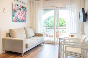 a living room with a couch and a window at Apartamentos Suaces in Noja