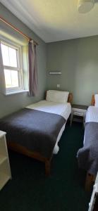 Ένα ή περισσότερα κρεβάτια σε δωμάτιο στο Holly Cottage 3 Bedroom