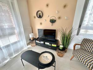 Televisyen dan/atau pusat hiburan di Appartement avec place de Parking à deux pas de la plage