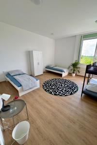 a bedroom with two beds and a large window at Wohnestate GmbH - Modern Living in Munich +33 photos