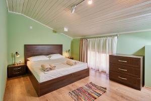 a large bedroom with a large bed and a dresser at Florance Rentals Luxury Apartments in Nessebar in Nesebar