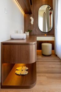 a bathroom with a wooden vanity with a mirror at Ellavie Villa Nusa Dua in Nusa Dua