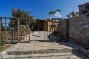 a gate to a building with a stone wall at Boutique House Thalassori in Agios Nikolaos
