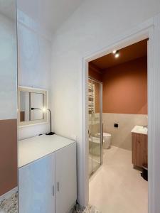 a white bathroom with a sink and a toilet at Borgo Design Apartment by the sea in Civitavecchia +19 photos