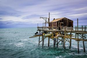 a small house on a pier in the water at Vista mare in Vasto