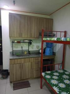a small kitchen with a bunk bed and a counter at Room for rent - SMR in Cebu City