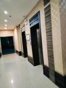 a hallway with three elevators in a building at Room for rent - SMR in Cebu City +12 photos