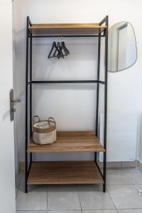a shelf with pairs of shoes and a basket on it at Studio des mers in Le Tréport