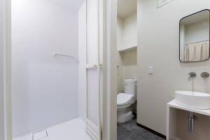 a bathroom with a toilet and a sink and a mirror at Jasmine Style Akasaka in Tokyo