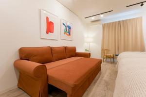 a living room with a couch and a bed at Jasmine Style Akasaka in Tokyo